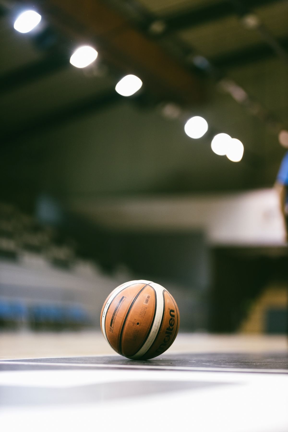 Game ball on the floor under arena lights